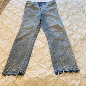 High waisted, light washed “boyfriend” jeans with pearl details on front side.